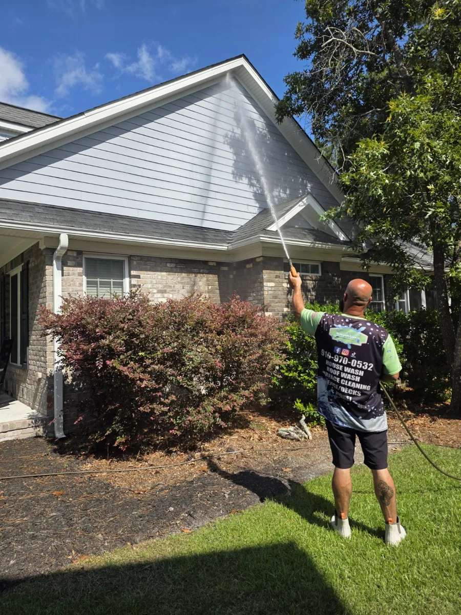 Don washing a home's exterior