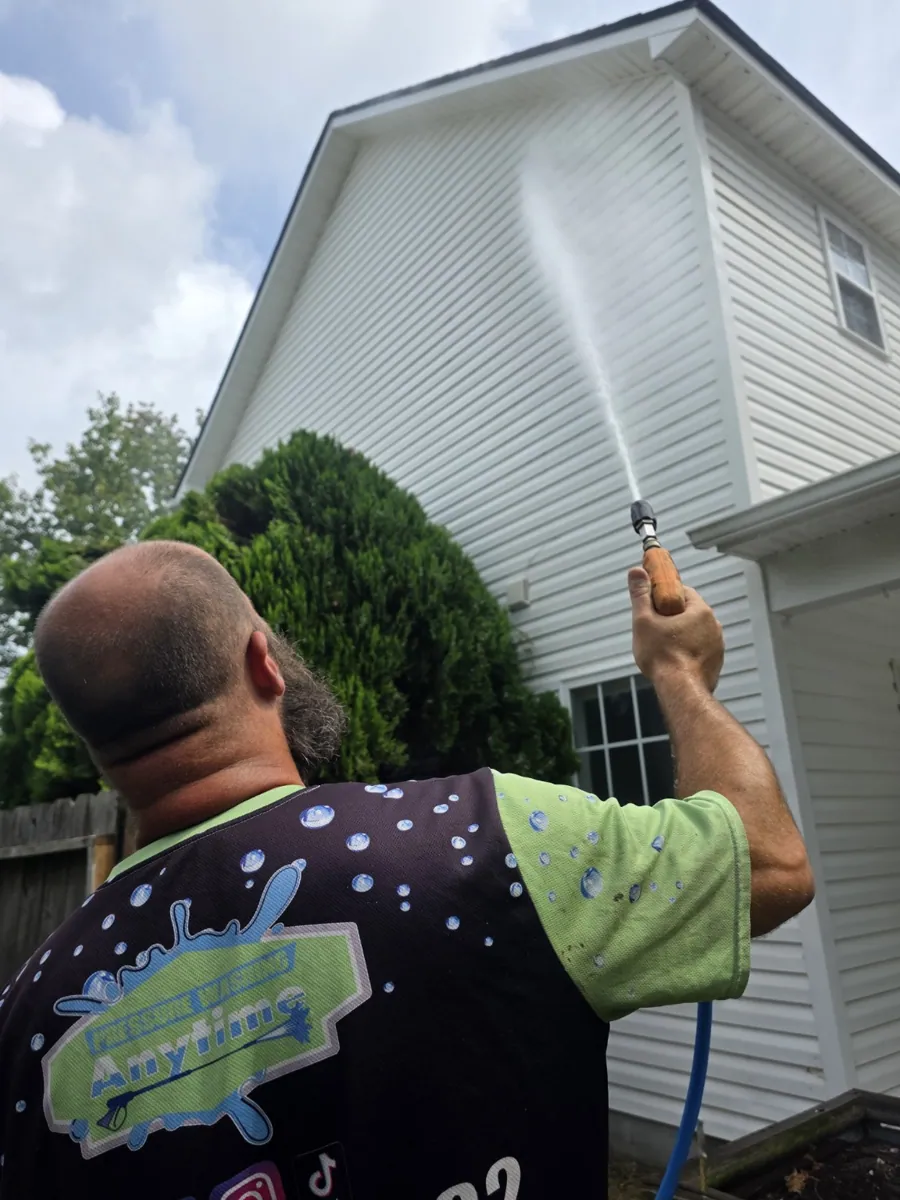 Don washing a two-story home