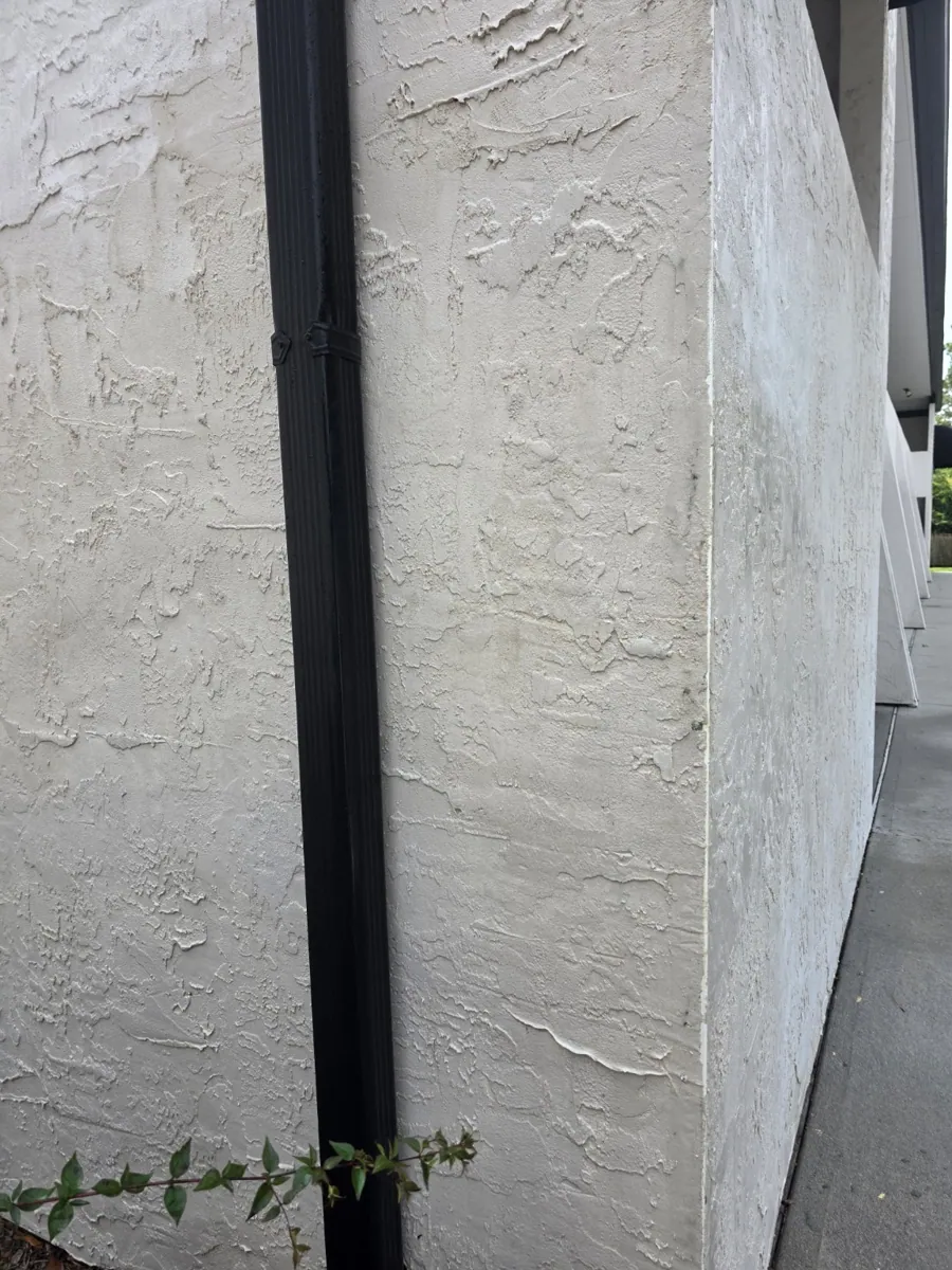 Same stucco wall after graffiti removal
